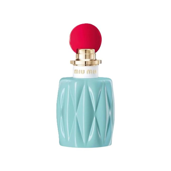 A turquoise bottle with a diamond-patterned design. A red spherical cap sits on top of the gold cap. The text "Miu Miu" is visible on the bottle.