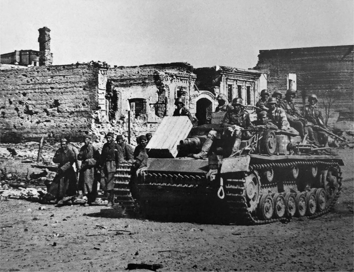 TheWorldatWar2's tweet photo. German soldiers hitch a ride on a StuG III as they make their way through the outskirts of Stalingrad - Aug 1942 #stug #stugiii #history #sovietunion #stalingrad #ww2 #ww2history https://t.co/WL8IXDbmZd