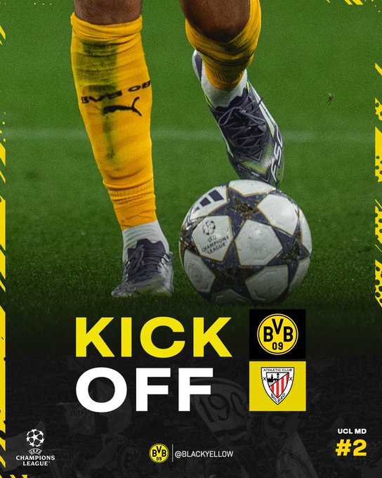 Yellow and black soccer socks with Puma branding, gray and black cleats, and a UEFA Champions League ball on green grass. The text "KICK OFF" and Borussia Dortmund logos are visible, along with Athletic Club Bilbao and UEFA Champions League branding.