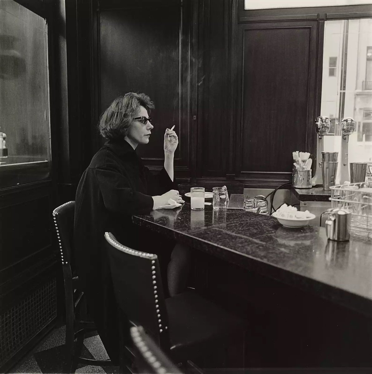 Diane Arbus #photography 
Woman at counter smoking, N.Y.C., 1962