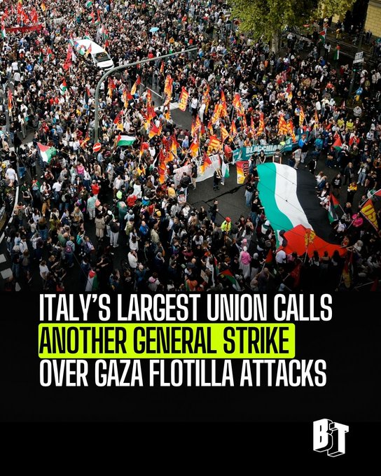 A large crowd of people gathered in a street, holding flags and banners. Visible flags include the Palestinian flag and others with red and yellow colors. A white vehicle is seen among the crowd. Text overlay reads "ITALY\'S LARGEST UNION CALLS ANOTHER GENERAL STRIKE OVER GAZA FLOTILLA ATTACKS" with a BreakThrough News watermark.