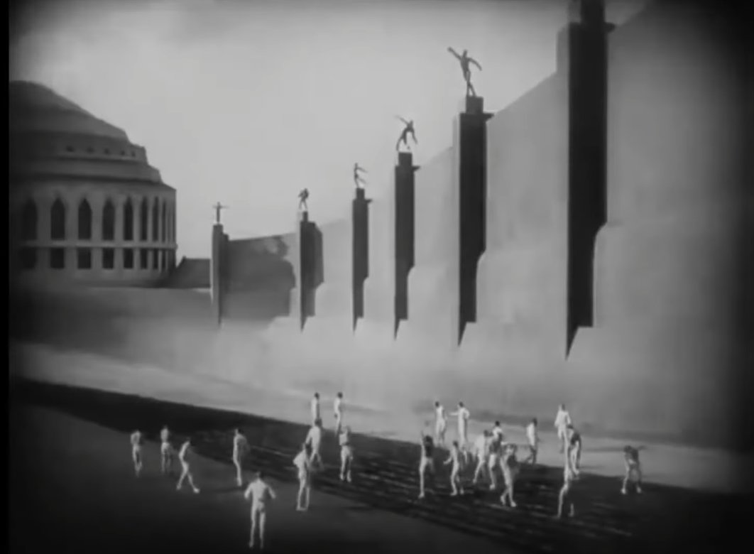 I cannot post anything on my side of production besides grey boxes and other evolutionarily jawless fish of level design, but I can recommend Fritz Lang's Metropolis.
If you ever needed to sell someone on the virtues of silent film, then I can't think of a better choice.