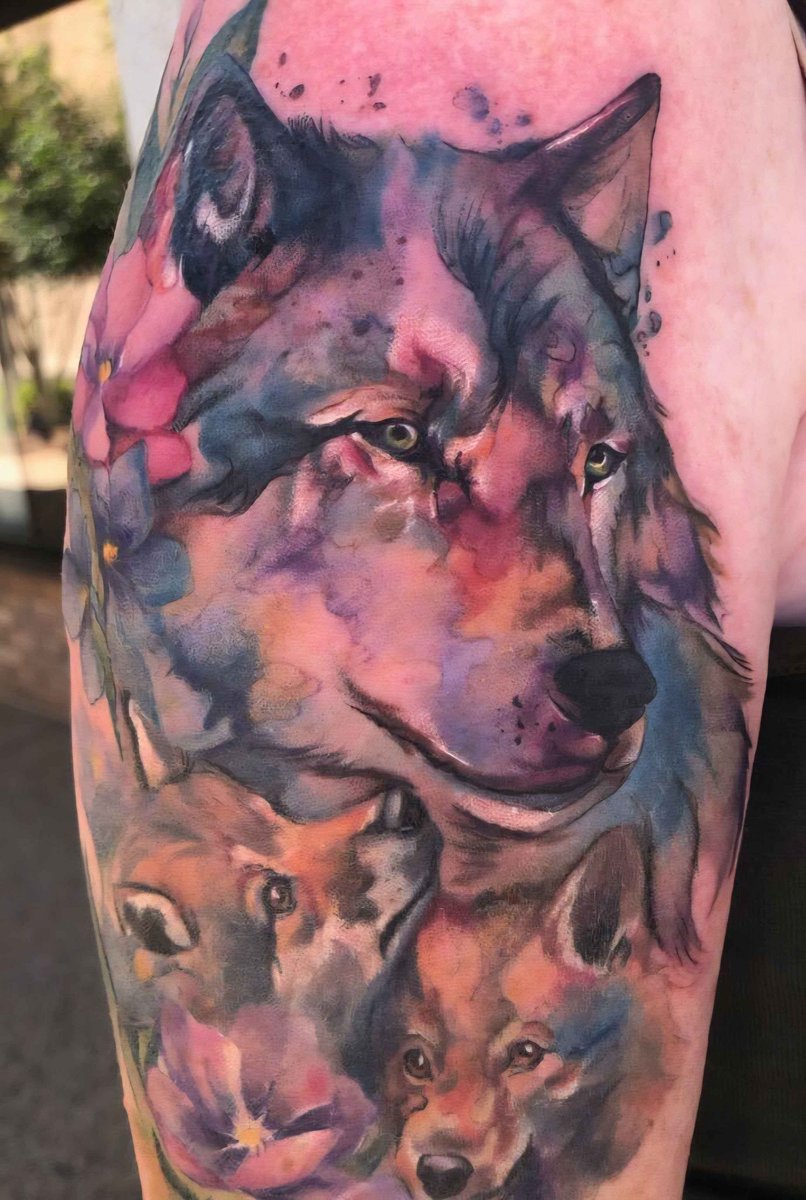 Mama wolf and pups, representing my sons and me. Completed yesterday. Absolutely in love. I have followed this artist's work for years and working with her on this piece was an honor &amp; dream come true. Last tattoo for '25, but I may have her refresh my dragon tattoo in '26.