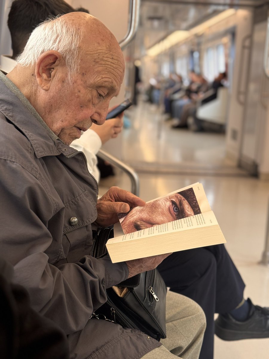 Ankara metrosunda kitap okuyan bir vatandaş.
