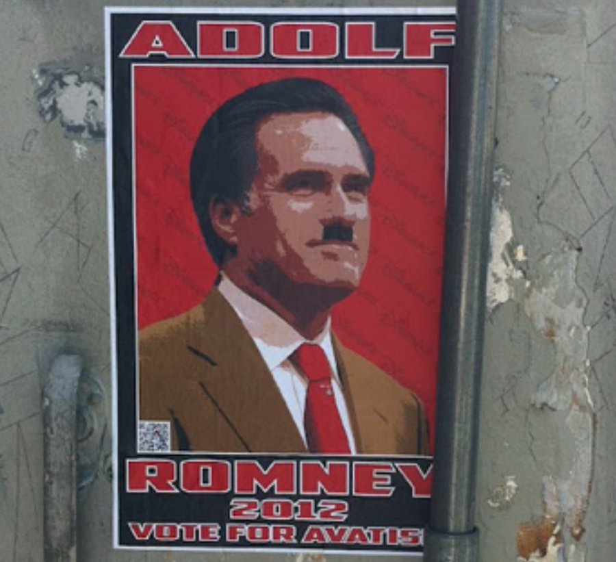 A red poster featuring Mitt Romney, depicted with a mustache, wearing a brown suit and red tie. The text on the poster reads "ADOLF ROMNEY VOTE FOR 2012" in bold white and black letters. A QR code is visible at the bottom.