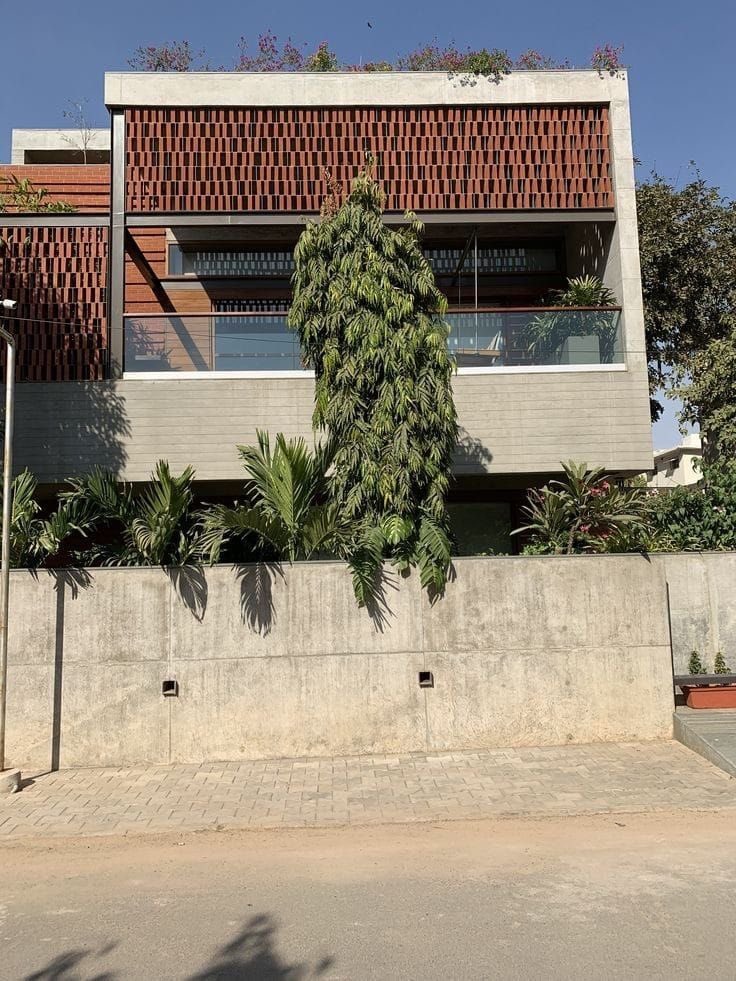 vangeorgh's tweet photo. Look at it this design - breeze blocks combined with railings to give a contemporary aesthetic.

Now, as a Nigerian tell me would you rather live in this climate-conscious, brutalist building with breeze blocks, shaded balconies, or those white bland boxes they’re selling everywhere?