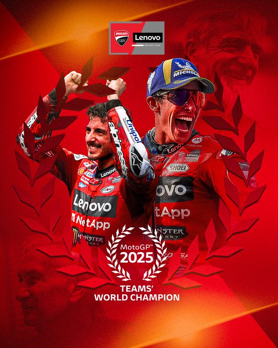 Two men in red Ducati Lenovo Team racing suits raising their arms in celebration. They wear helmets and sunglasses, with visible logos for Lenovo, Monster Energy, and Michelin. A laurel wreath design and text reading "2025 TEAMS WORLD CHAMPION" are overlaid on a red background.