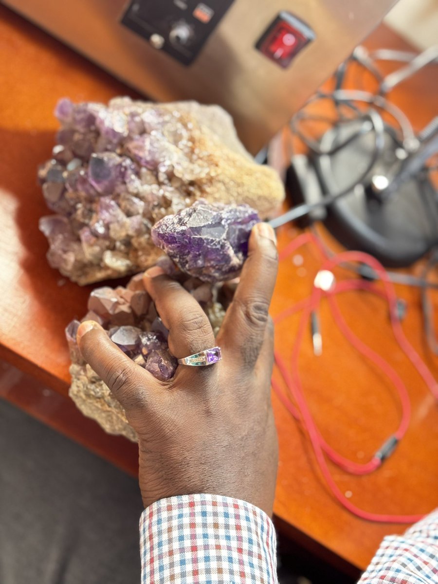 ApolloBuregyeya's tweet photo. The stone. The rough. The ring.
=====

This is Kisoro amethyst. Born in our soil, carried in its natural rough beauty, and polished in Uganda by @ecoconcreteUG’s Gemstones Workshop. Very few nations have a stone that grounds their people, a symbol to wear, to claim, and to identify with. For Uganda, amethyst is not just a gem; it is an anchor of value, dignity, and pride.

When we wear it, we do more than adorn ourselves. We affirm that our wealth does not need foreign signatures. We make our minerals speak for us, not for others.

Renegades wear amethyst. For you, it stands as a symbol of calm in storms, balance in chaos, clarity in decision, and strength against negativity. It reflects discipline of the mind, steadiness of the spirit, and dignity in the hand that wears it.