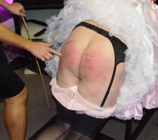 Brian's dress pulled up, and his pink panties pulled down for a very strict spanking!