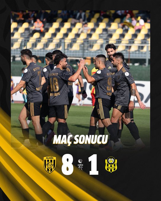 Group of male soccer players in gray jerseys with yellow accents and numbers like 18 and 9 on their backs stand on a green field in a stadium with empty yellow seats in the background, raising their hands in celebration while facing the camera, with a score overlay showing 8 to 1 between team crests resembling bees.