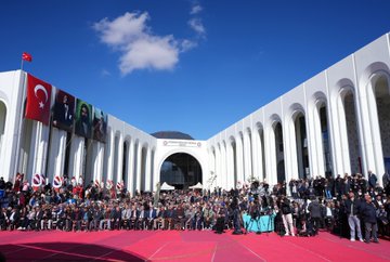 First image shows a blue backdrop with Turkish text reading Horasan Erenleri Dergahı Cemevi and 1. Etap Açılış Töreni dated 11 Ekim 2025, featuring a man in a suit speaking at a podium with microphones, surrounded by banners of Horasan Erenleri and chairs on a stage. Second image depicts a group of men and one woman in formal suits and dresses sitting and clapping at an outdoor event under a canopy, with water bottles and glasses on a table in front. Third image displays a large white arched building with Turkish flags and banners, a crowd of people in suits standing on a red carpeted area under a blue sky with clouds. Fourth image captures a line of officials including men and women in suits and dresses holding a ribbon on a blue stage with lights and text banners for Horasan Erenleri Dergahı Cemevi 1. Etap dated 11 Ekim.