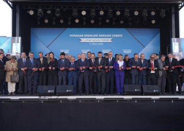 First image shows a blue backdrop with Turkish text reading Horasan Erenleri Dergahı Cemevi and 1. Etap Açılış Töreni dated 11 Ekim 2025, featuring a man in a suit speaking at a podium with microphones, surrounded by banners of Horasan Erenleri and chairs on a stage. Second image depicts a group of men and one woman in formal suits and dresses sitting and clapping at an outdoor event under a canopy, with water bottles and glasses on a table in front. Third image displays a large white arched building with Turkish flags and banners, a crowd of people in suits standing on a red carpeted area under a blue sky with clouds. Fourth image captures a line of officials including men and women in suits and dresses holding a ribbon on a blue stage with lights and text banners for Horasan Erenleri Dergahı Cemevi 1. Etap dated 11 Ekim.