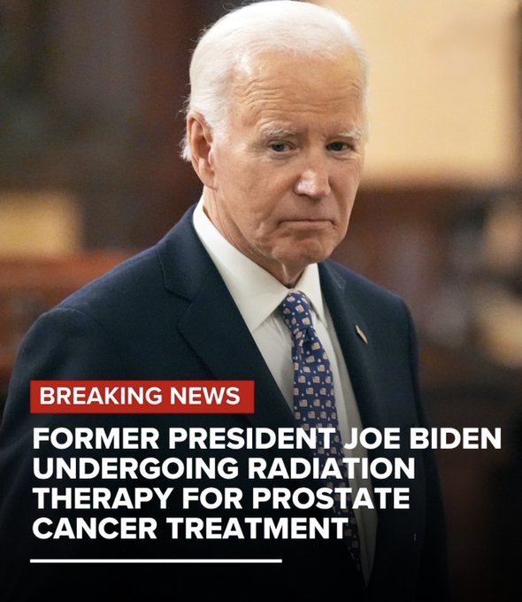Elderly man with white hair wearing a dark suit white shirt and blue patterned tie stands in front of a beige curtained background looking serious. Red breaking news banner overlay at bottom reads FORMER PRESIDENT JOE BIDEN UNDERGOING RADIATION THERAPY FOR PROSTATE CANCER TREATMENT.