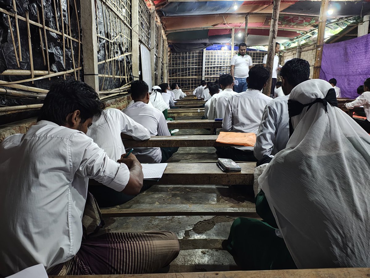 Rohingya_PS's tweet photo. For the first time, over 2,500 #Rohingya refugee students in 🇧🇩 are taking mid-term exams under a structured board system, marking a historic step toward equal education rights. Despite funding challenges, the community has worked hard to make this milestone a reality. 📷 sayed https://t.co/VS0k7p4NzD