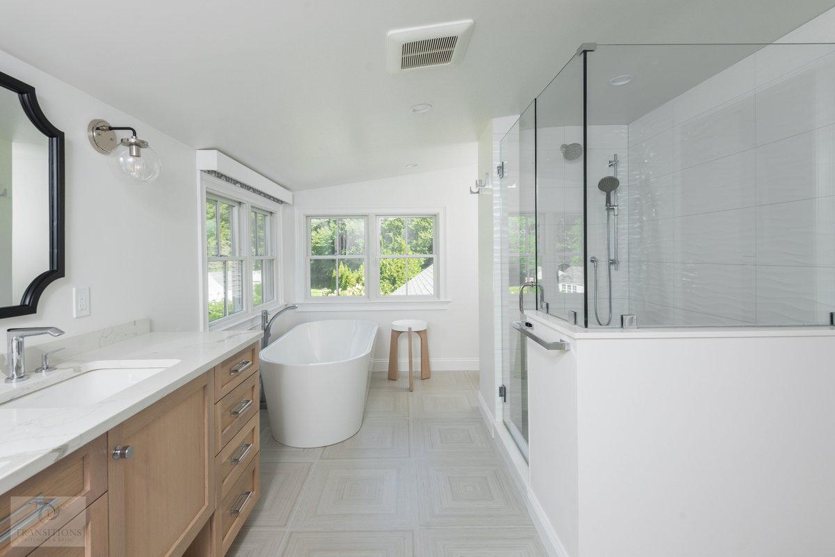 Transitionskbr's tweet image. A wood vanity brings warmth to this bright, spa bathroom. Two black-framed mirrors complete the look, creating a stunning focal point. Ready to start your bath remodel? Let’s chat! (781) 871-0881 

#BathroomDesign #BathRemodel #SpaVibes #VanityDesign #TransitionsKitchensAndBaths