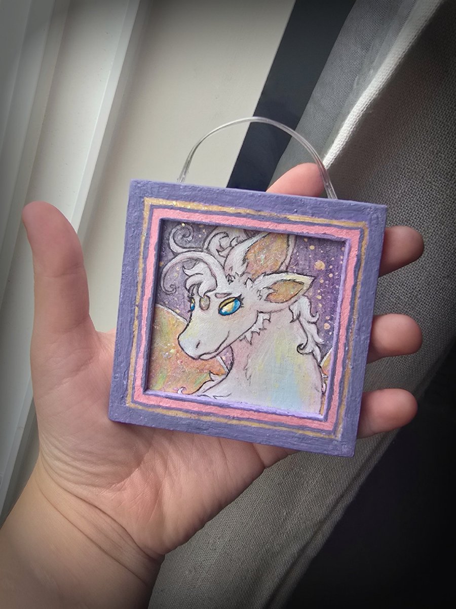 Soft friend!!

Hand painted with acrylics on a thrifted $0.25 frame, with a hanging fixture made of old wires from a broken string of LED lights. The camera couldn't capture any of the rainbowy glitter, but it looks super sparkly in person :)