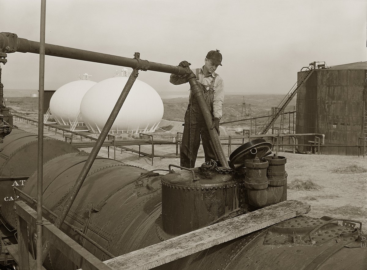 A Phillips refinery worker in Borger, Texas,  fills a tank car with fuel oil, 1942.  A remarkable photo in every way. Stunning clarity.  

Taken by John Vachon.