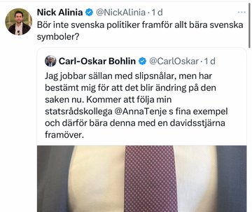 A photo of Carl-Oskar Bohlin wearing a suit and tie with a Davidsstjärna (Star of David) pin on the tie. The background shows a blurred indoor setting, possibly a formal or parliamentary environment.