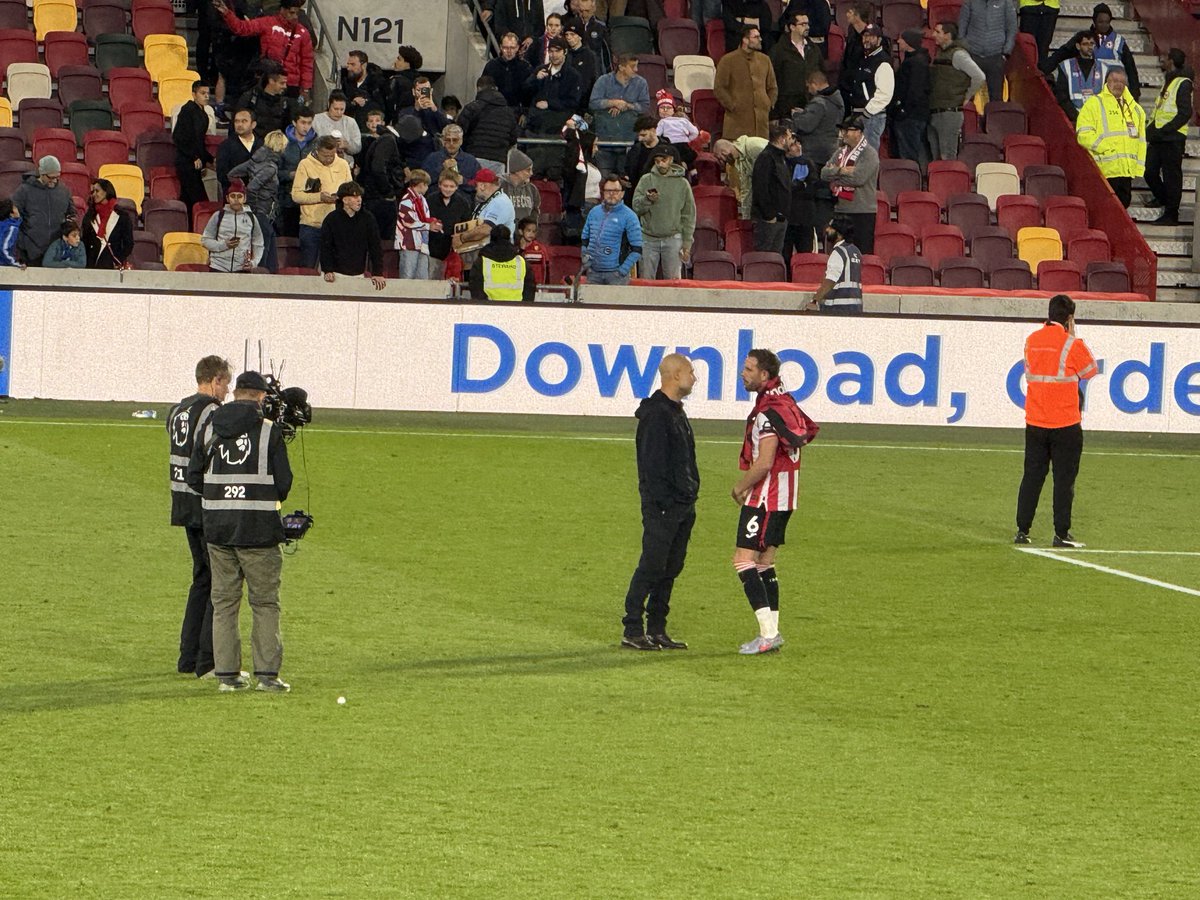 Manchester City boss Pep Guardiola and Brentford’s Jordan Henderson in prolonged discussion after the match here in west London