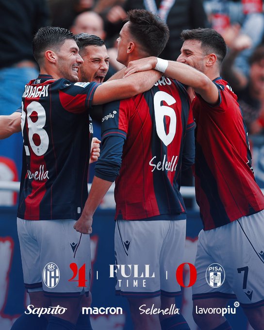 Three soccer players in red and blue jerseys with numbers 28, 6, and another visible on their backs, embracing on a field. The jerseys display names "Zaccagni", "Saelemaekers", and another partially visible name. The background shows a crowd of spectators. Text overlays show "BFC 2-1 FULL TIME PISA 0" and logos for Saputo, Macron, Selezione, and lavoropi.
