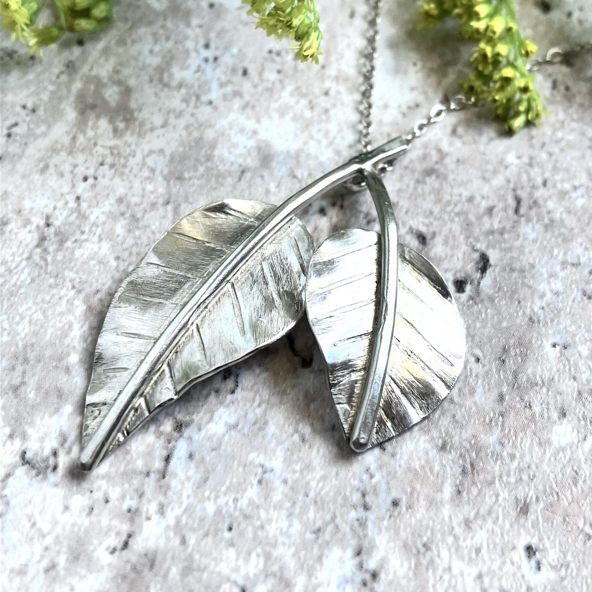 Another “Fall” piece…Double Leaf Pendant Necklace.  Very simple and very versatile.  I kept it neutral by only adding petite, faceted silver glass beads and itty bitty spinel gemstones.

bellarosejewelrydesign.com/product/double…