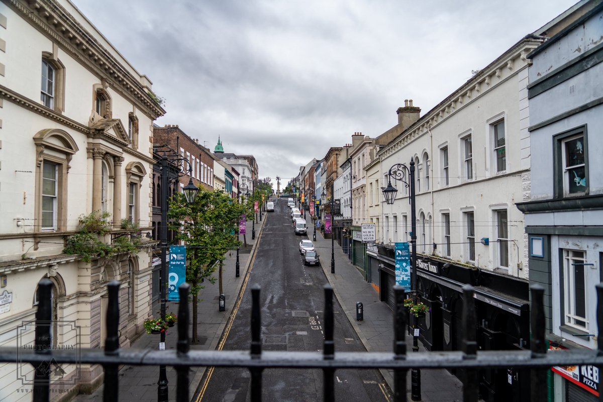 FentonPhoto's tweet photo. Looking up the street in Derry/Londonderry, Northern Island. #streetphotography #cloudysky #buildings #citystreet #Derry #Londonderry #NorthernIreland #highangleview #fence #travel #vacation #photography @NorthernIreland @VisitDerry https://t.co/atcWmXnzk1