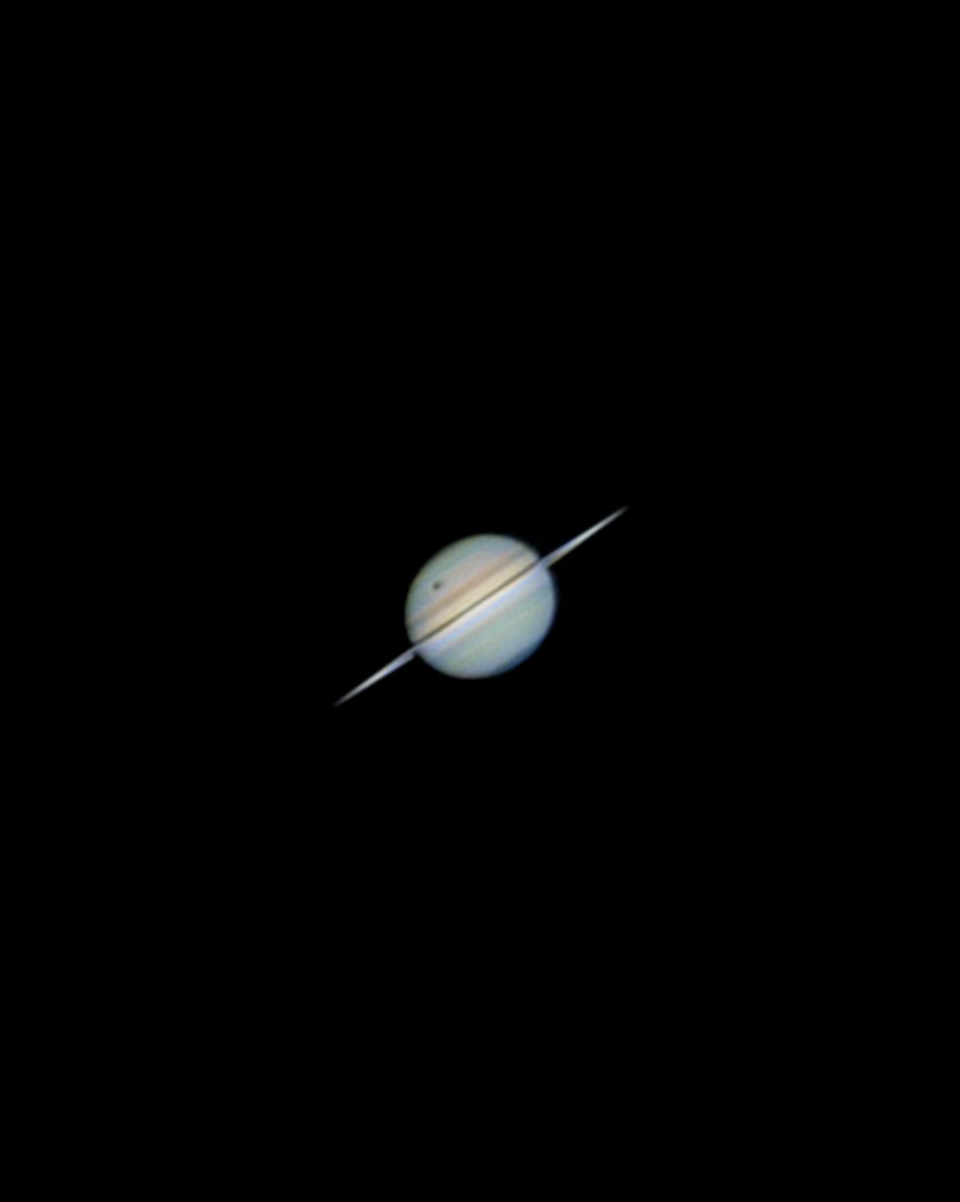 This photo of Saturn was taken 5 minutes ago with my telescope. 

That black dot? Titan, Saturn's largest moon, is transiting for the last time until the 2040's. 

More photos (and hopefully a timelapse) to come!