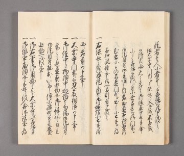 Open aged booklet with Japanese calligraphy on cream paper showing detailed black ink characters arranged in vertical columns across both pages describing historical event details in classical script style. Second image displays another open page of similar booklet with intricate vertical text in black ink on aged paper capturing formal records of locations and procedures.