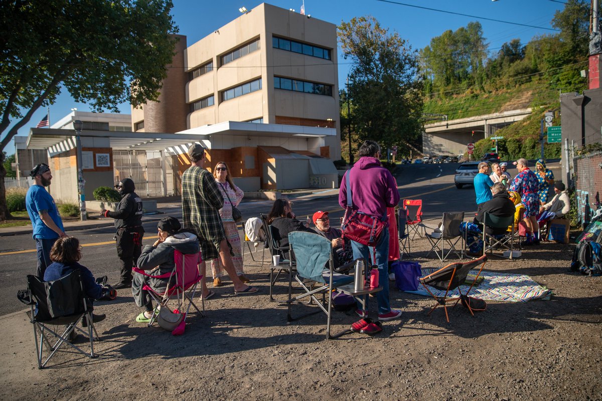 markwgraves's tweet photo. An out-of-control, pajama-clad crowd in lawn chairs, armed with coffee and doughnuts, gathered outside the U.S. Immigration and Customs Enforcement (ICE) building in South Portland on Sunday for the Portland Pastry and Pajamas Protest. Two people were even throwing a frisbee. https://t.co/w1KICmmH58