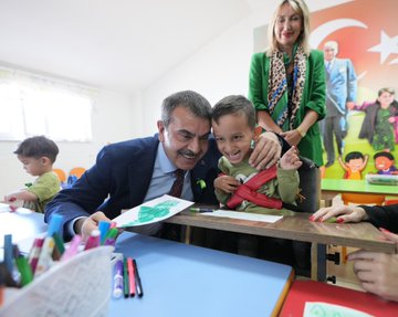 Yusuf Tekin and İbrahim Yumaklı in a classroom with children, some in wheelchairs, engaging in drawing activities at tables with colorful supplies. A woman in a green jacket stands behind, smiling. Walls display educational posters and a large Turkish flag mural. Another image shows Yusuf Tekin, İbrahim Yumaklı, and others standing with students, some in wheelchairs, in a school setting with a banner reading "Duruça Zerenok." A third image depicts a group of people, including Yusuf Tekin and İbrahim Yumaklı, posing outside a school building with green decorations and traffic cones.
