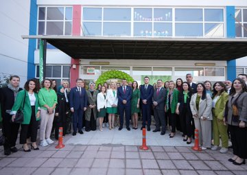Yusuf Tekin and İbrahim Yumaklı in a classroom with children, some in wheelchairs, engaging in drawing activities at tables with colorful supplies. A woman in a green jacket stands behind, smiling. Walls display educational posters and a large Turkish flag mural. Another image shows Yusuf Tekin, İbrahim Yumaklı, and others standing with students, some in wheelchairs, in a school setting with a banner reading "Duruça Zerenok." A third image depicts a group of people, including Yusuf Tekin and İbrahim Yumaklı, posing outside a school building with green decorations and traffic cones.