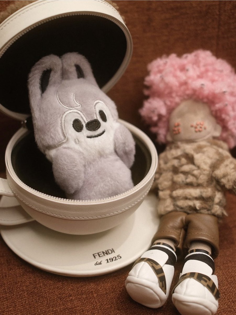 Paired with a meticulously crafted cappuccino, adorned with a frothy design, this scene embodies the perfect harmony of high fashion and cozy indulgence. Ideal for those who cherish both style and comfort in their daily treasures.