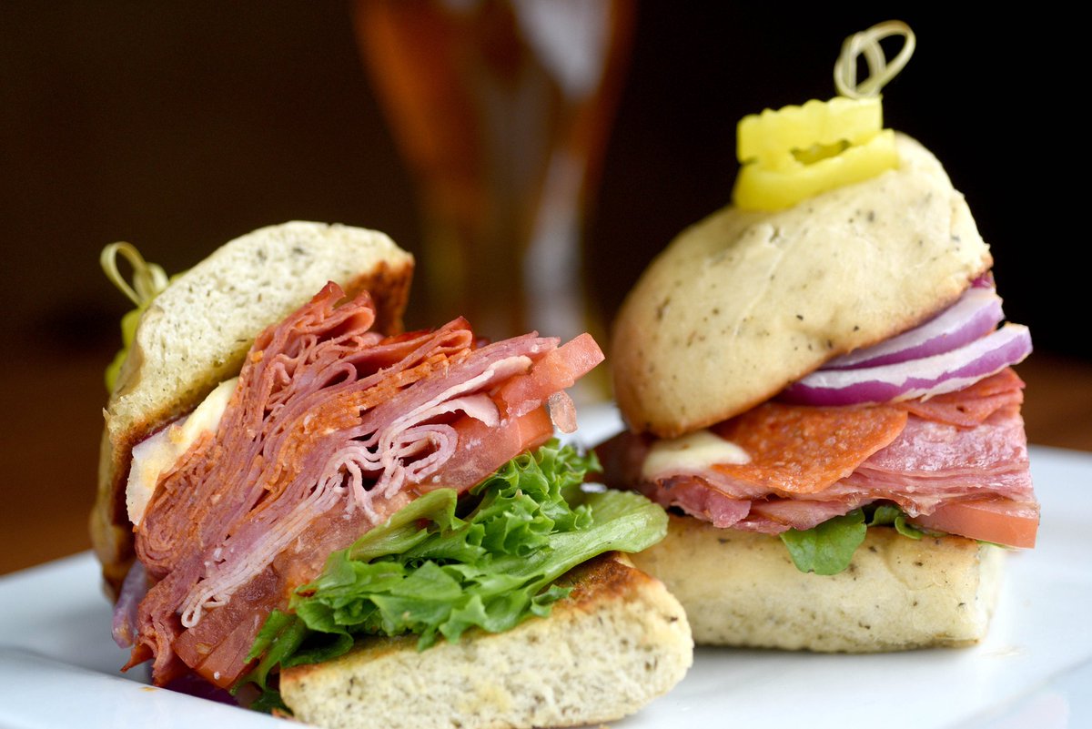 Savor the flavors of our Hot Italian! Salami, ham, pepperoni, capicola meet fresh mozzarella and veggies, all drizzled with herb vinaigrette on toasted garlic herb bread 🥖🇮🇹 A true feast for the taste buds! #GrindstoneTapHouse #TasteOfItaly 🍅🧀