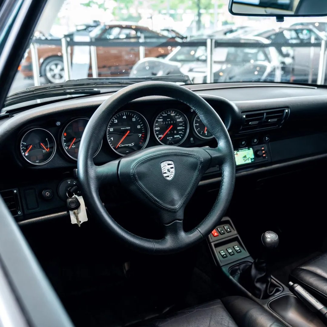 Bringatrailer's tweet photo. This Japanese-market 1997 Porsche 911 Carrera S coupe is one of a reported 60 Vesuvio Edition cars produced, all of which feature Vesuvio Metallic paintwork with Steel Gray accents. Showing ~13k miles, it's listed now in Hamburg, Germany, on BaT!

https://t.co/XeKnWBKrPx https://t.co/m2vru7A5uI