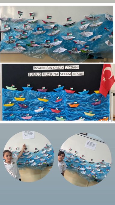 First image shows a classroom wall display with numerous small paper boats in blue and white, adorned with UAE flags, arranged in rows against a blackboard with Turkish text reading SUMINSI OLANA SELAM OLANA and a Turkish flag. Second image depicts a framed portrait of Mustafa Kemal Ataturk on the wall, a sign in Turkish saying INSANLIK SUMINSI SELAM SUMINSI, and a girl in school uniform standing beside a blue wavy display of paper boats with UAE flags. Third image captures two girls in white uniforms sitting at a table drawing on large paper sheets depicting a colorful world map with peace doves, Palestinian and other flags, butterflies, and green plants using colored pencils. Fourth image features a classroom wall with a sign in Turkish INSAN OLANA SUM OLANA SELAM OLANA, a girl in uniform pointing to a blue wavy display of paper boats decorated with UAE flags.