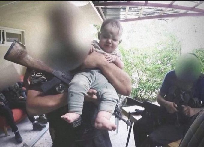VividProwess's tweet photo. Hamas brutally killed Adi Kaploun, a 33-year-old mother, right in front of her helpless baby on October 7th.

Immediately afterward, they took a photo with her baby while Adi's lifeless body lay on the ground inside the house.

This is why Israel is at war, if anyone asks. https://t.co/ClpkAet4EV