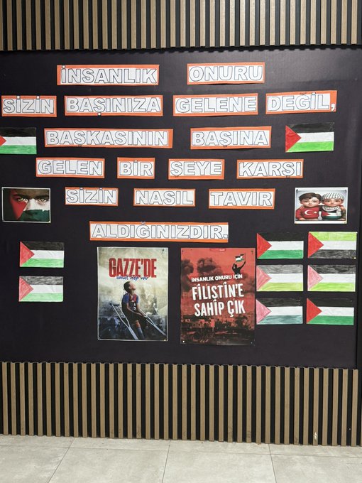 First image shows corner of classroom with wooden walls black bulletin board covered in Palestinian flags posters of children and text in Turkish about awareness multiple small flags and drawings attached. Second image displays large black board with bold Turkish text reading İNSANLIK ONURU SİZİN BAŞINIZA GELEN DEĞİL BAŞKASININ BAŞINA GELEN BİR ŞEYE KARŞI SİZİN NASIL TAVIR ALDIĞINIZDIR surrounded by Palestinian flags photos of children and Turkish flag poster titled GAZZE FİLİSTİN FİL SAHİBİ ÇOCUK. Third image features wide black board with various posters including Palestinian flags childrens drawings photos of people and symbols like peace signs arranged in educational layout. Fourth image depicts group of young students in school uniforms standing and pointing at similar black board with flags posters and text one child gesturing towards display.