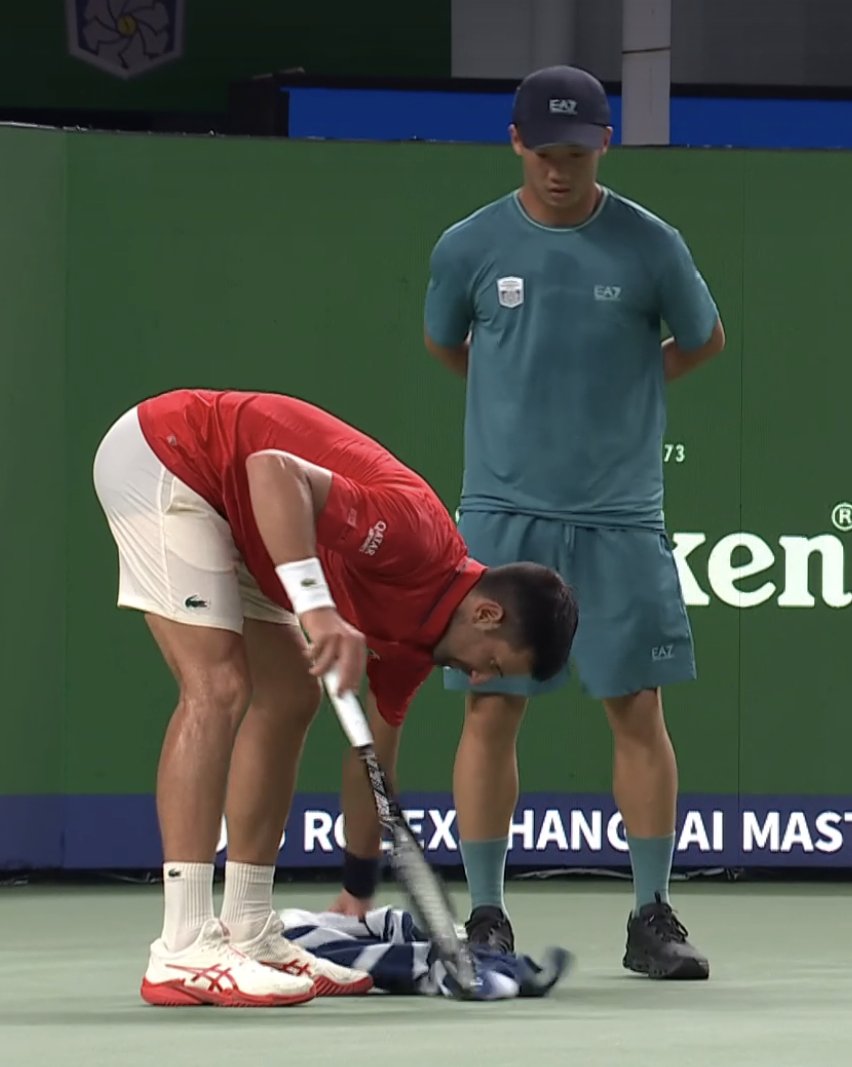 Novak Djokovic just threw up on court and is cleaning up after himself so the ball kids don't have to.