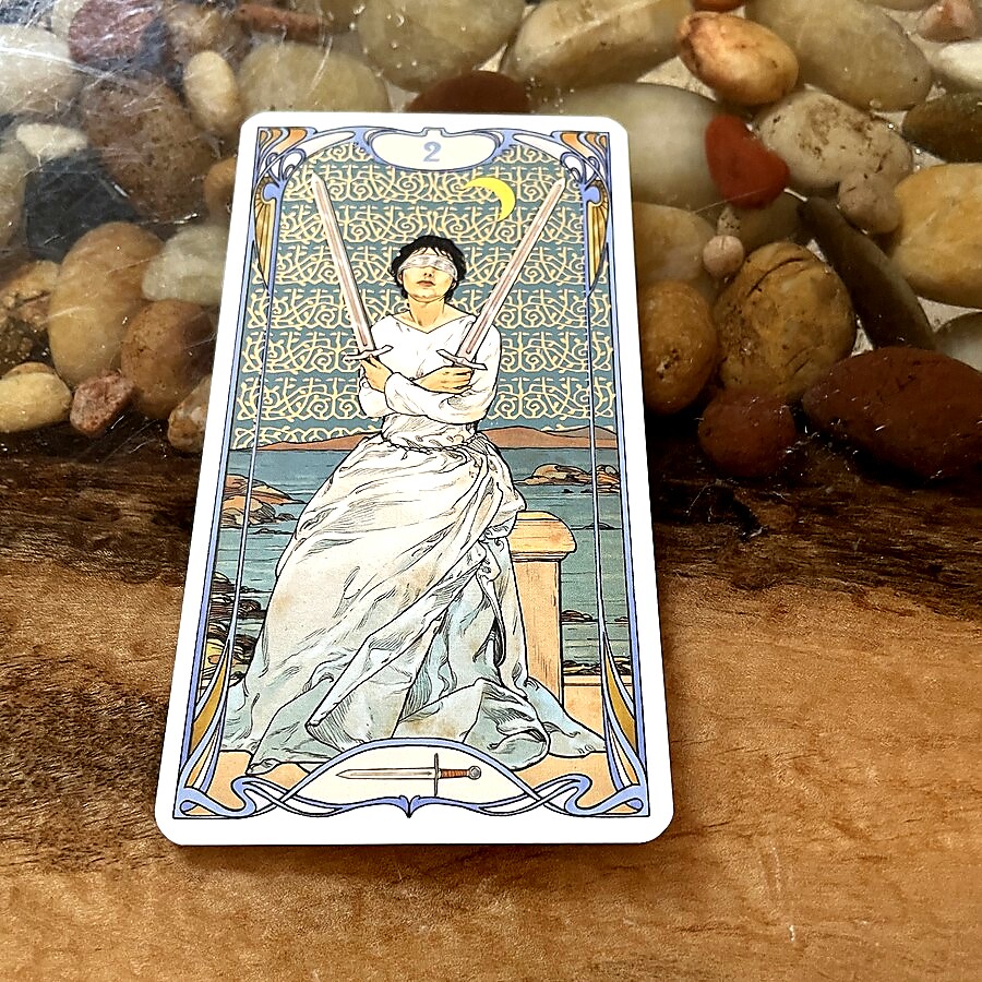 El 2 de Espadas propone paz interior forzada y equilibrio mental.