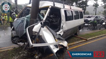 First image shows firefighters in orange and yellow uniforms and helmets using tools near a white vehicle door on a rainy street with traffic cones and other responders in green vests nearby. Second image depicts multiple firefighters in red helmets and red uniforms attending to a patient on a stretcher beside a white car on a wet road with trees and other personnel in background. Third image displays a damaged white van crashed into a pole on a rainy roadside with firefighters in yellow gear inspecting the wreckage and debris scattered around.