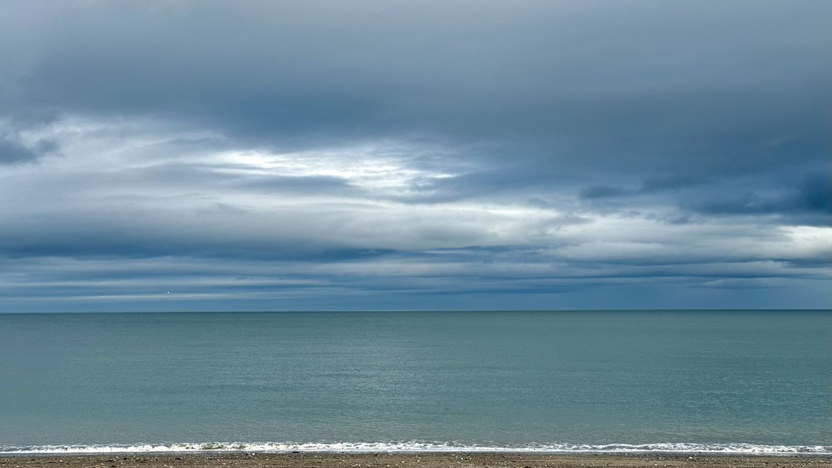 A calmness and utter stillness in the air.  Sea the colour of jade sits under a lowering sky of grey and white this afternoon at Killiney beach, Co. Dublin, Ireland.