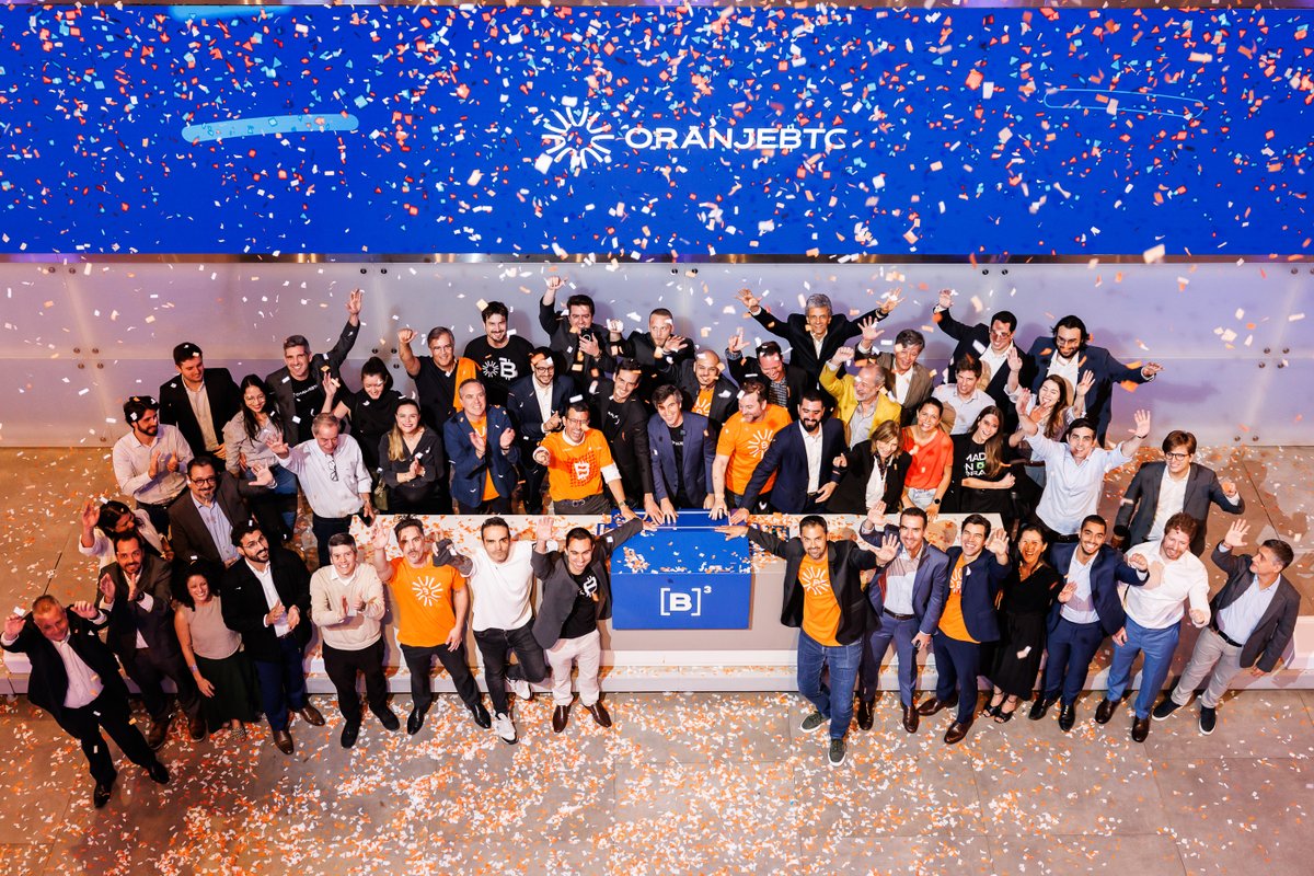 OranjeBTC team celebrating their listing on the B3 stock exchange with confetti and cheers