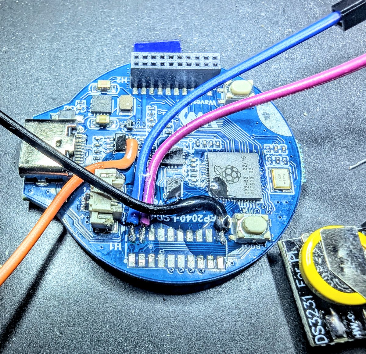 montaelkins's tweet image. My UV glasses to harden my clear fingernail polish w/ UV light. The polish insulates and tacks down the small wires I soldered.
RP2040 with a 1.28" color LCD display.
No good place to grab 3.3V volts except directly on the voltage regulator output pin. :(
#HardwareHacking