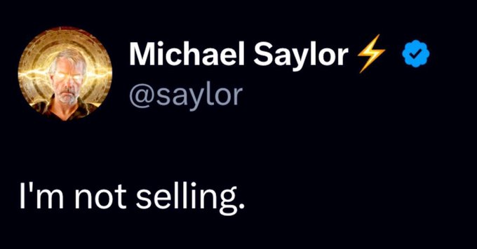 Circular golden halo surrounds the head of a man with white hair and beard, wearing a suit, labeled Michael Saylor with blue checkmark and lightning bolt emojis, username @saylor, and text I am not selling below in white on black background.