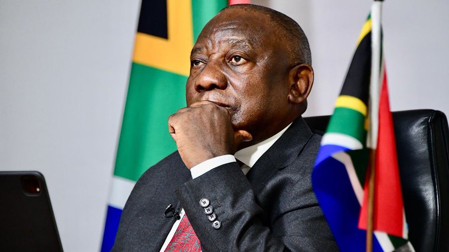 First image depicts Cyril Ramaphosa an elderly Black man with short hair wearing a dark suit white shirt and red tie seated in a black leather chair with hand on chin in thoughtful pose South African flags in green black yellow red white and blue colors visible behind him against a light background. Second image shows Benjamin Netanyahu an elderly man with gray hair wearing a dark suit white shirt and tie standing indoors with wooden paneling behind him gazing forward with serious expression.