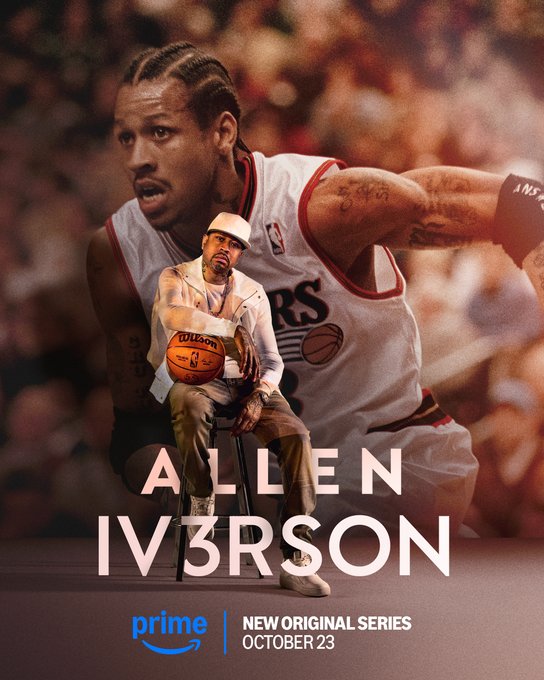 Allen Iverson in a white Philadelphia 76ers jersey with red accents holding a basketball while seated in a stadium crowd wearing a cap and showing tattoos on his arms with bold text ALLEN IV3RSON overlay and Prime Video logo indicating new original series premiering October 23