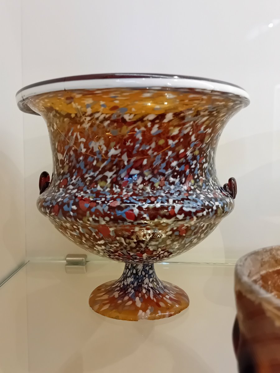 A #Roman glass cup, in amber glass with irregular blue, red, &amp; white splodgy decoration #Archaeology #RomanArchaeology