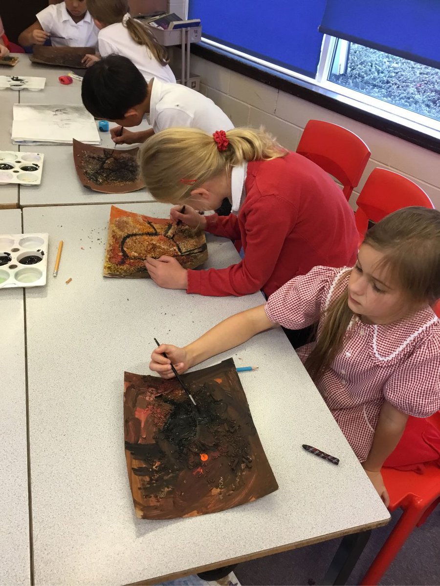 Class 8 have been finishing their prehistoric cave paintings using black paint to outline.