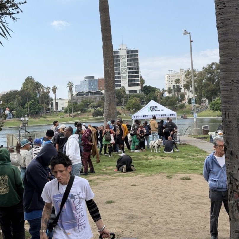 Feed The People event distributing food in a park, powered by Solana meme token
