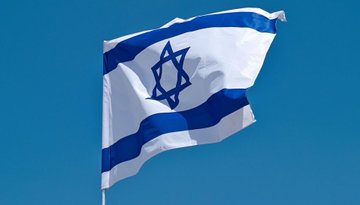 First image shows a formal portrait of Donald Trump wearing a blue suit white shirt and blue tie standing in front of an ornate gold-framed background with an American flag positioned to his left. Second image displays the blue and white Israeli flag with the Star of David centered waving against a clear blue sky on a flagpole. Third image depicts a person from behind wearing a white and black checkered keffiyeh raising a Palestinian flag with red black green and white colors over a cloudy sky with urban buildings and power lines visible in the background.
